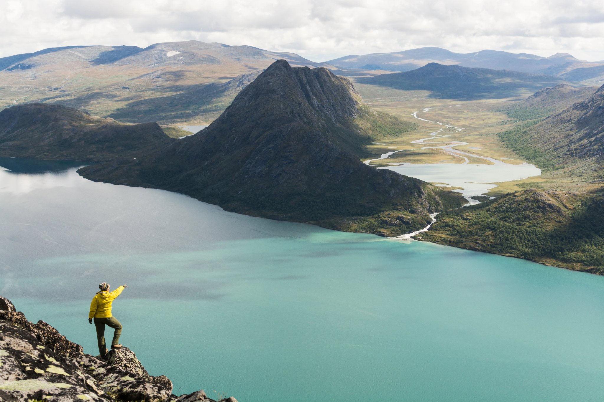 Girl standing on Besseggen ridge overlooking Gjende and Ovre Leirungen lakes, Norway