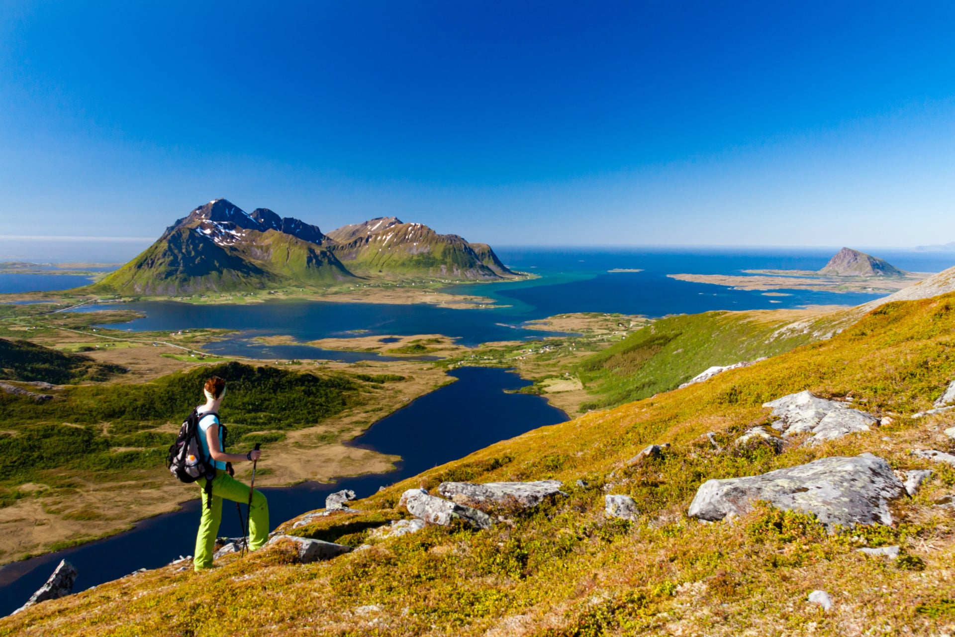 Girl hiking in Lofoten mountains among fjords, Lofoten islands, Norway