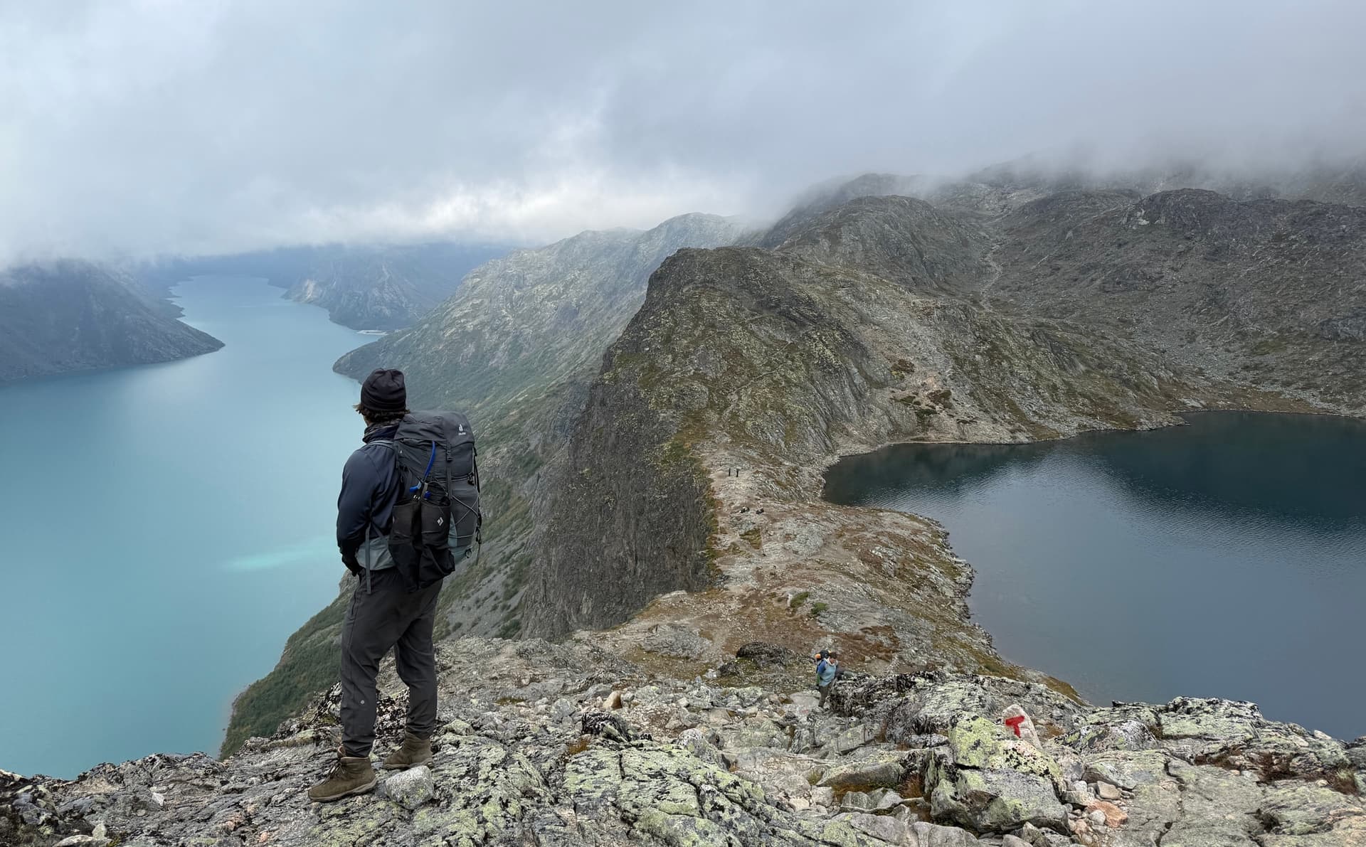 Hiker on Besseggen ridge overlooking two lakes in Norway