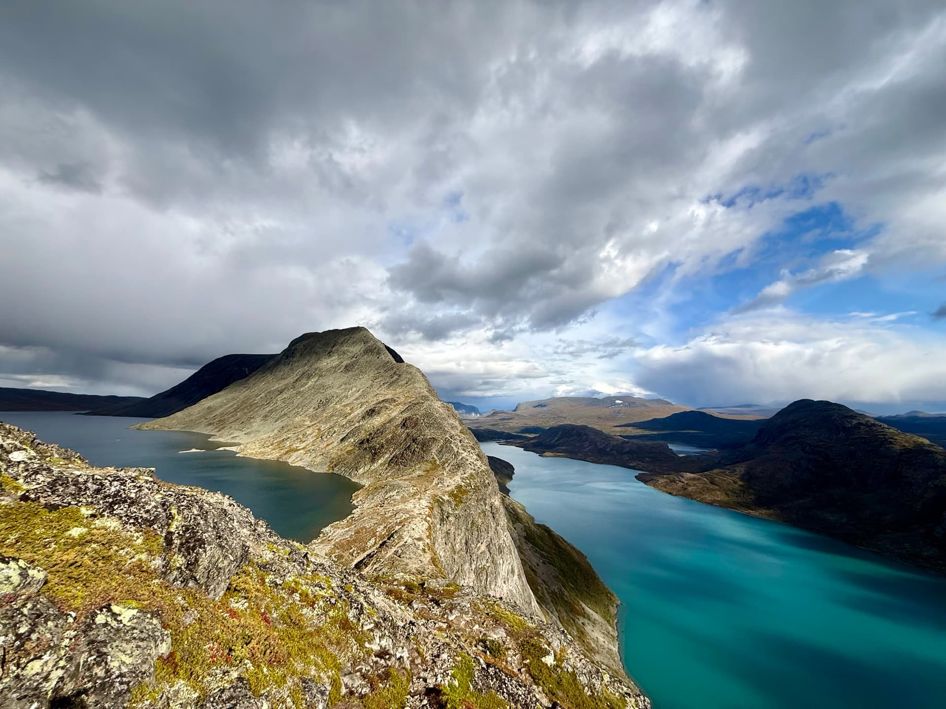 Besseggen ridge with turquoise lake and dramatic cloudy sky